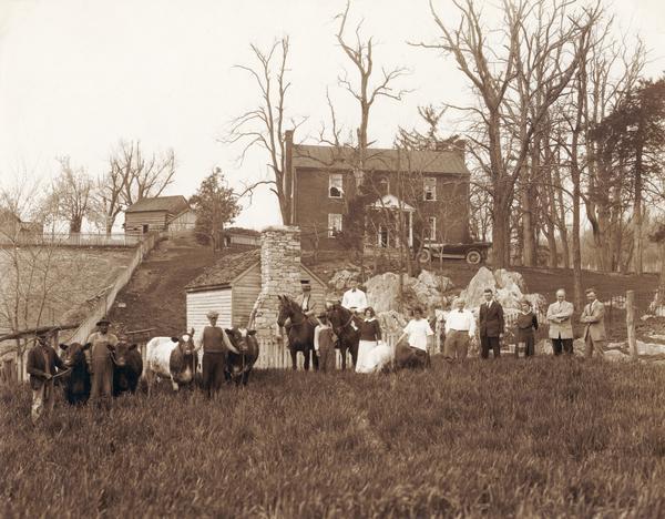 Harold F. McCormick family, farm laborers, and various animals on the Walnut Grove estate at Raphine, Virginia. Harold McCormick was the son of Cyrus Hall McCormick, and a president of the International Harvester Company. Walnut Grove was the boyhood home of Cyrus Hall McCormick. Pictured (L to R) are: three unidentified farm hands, Muriel McCormick (on horse), unidentified farm hand, Fowler McCormick (on horse), Mathilde McCormick, Julia Mangold, Howard Colby, unidentified man, Kathleen (Mrs. Rush) Searson, Harold F. McCormick, and (J.) Rush Searson.