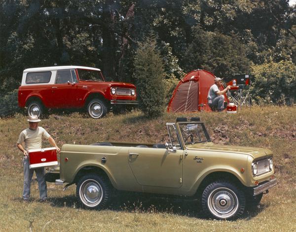 Color advertising photograph of two men setting up camp in a wooded area. The men have two 1972 International Scouts, one a 4x4 with the top removed (foreground) and the other a standard model.