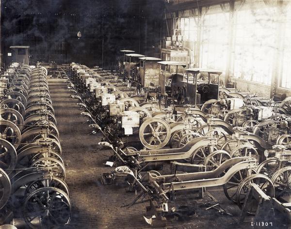 Elevated view of rows of Mogul and Titan tractors in various stages of assembly at International Harvester's Tractor Works. The factory was in operation from 1910-1972, and was located at 2600 West 31st Blvd.