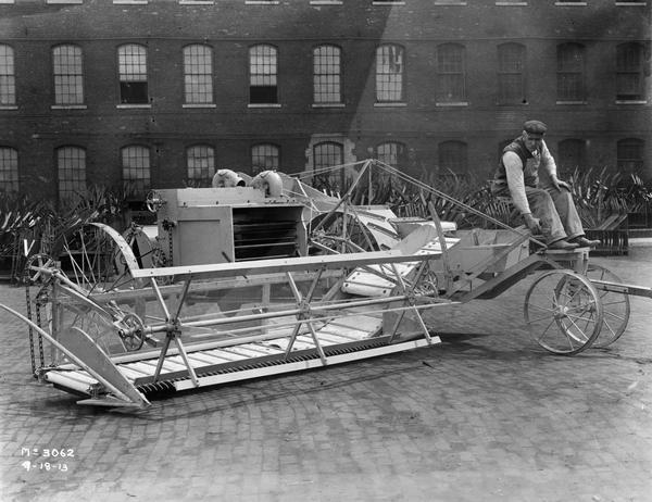 McCormick experimental pull-type harvester-thresher (combine) outside International Harvester's McCormick Works. The machine is one of two models that were the first experimental harvester-threshers built at McCormick Works. Neither model went into production.