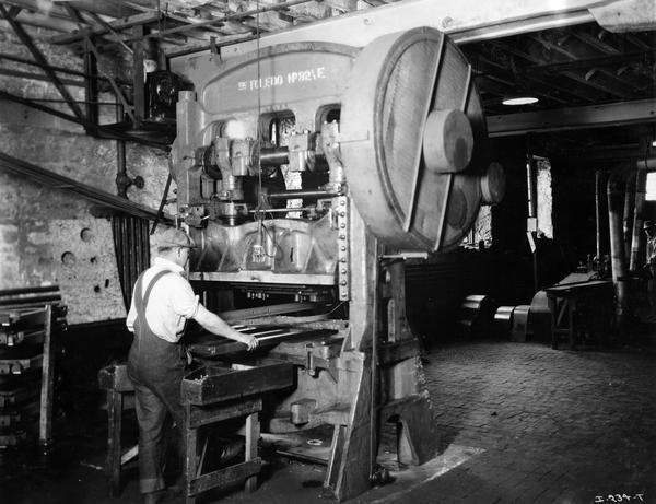 Factory worker machining an implement part at International Harvester's Rock Falls Works. The factory was owned by the Keystone Manufacturing Company before 1904. From 1904-1919 the factory was known as the Keystone Works.