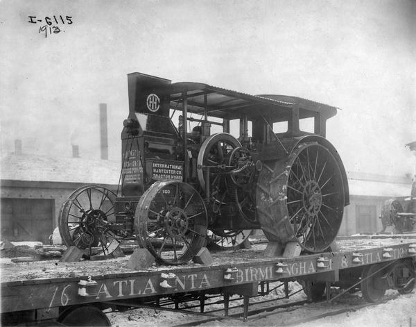 Mogul 15-30 HP kerosene tractor loaded on a railroad car for delivery, most likely outside International Harvester's Tractor Works.