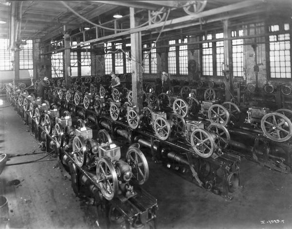 Workers inspecting rows of IHC engines at International Harvester's Deering Works. The factory was owned by the Deering Harvester Company before 1902, and was located at Fullerton and Clybourn Avenues.