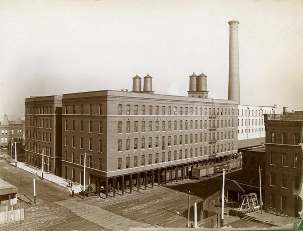 Twine mill with shipping platform at the McCormick Reaper Works, just after construction. The factory was owned by the McCormick Harvesting Machine company before 1902. In 1902 it became the McCormick Works of the International Harvester Company. The factory was located at Blue Island and Western Avenues in the Chicago subdivision called "Canalport." It was closed in 1961.