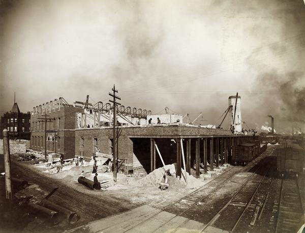 Elevated view of a twine Mill under construction at the McCormick Reaper Works. The factory was owned by the McCormick Harvesting Machine company before 1902. In 1902 it became the McCormick Works of the International Harvester Company. The factory was located at Blue Island and Western Avenues in the Chicago subdivision called "Canalport." It was closed in 1961.