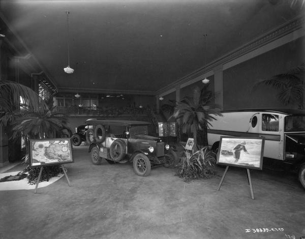 Showroom featuring the Special Delivery truck (center) that crossed the Sahara Desert from 1927-1928. There is a framed map on an easel on the left.
