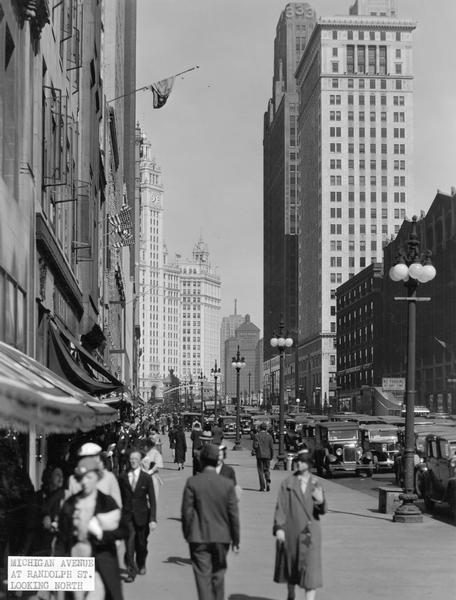 Street scene of Michigan Avenue and Randolph Street in Chicago. The Allerton Hotel is in the background.