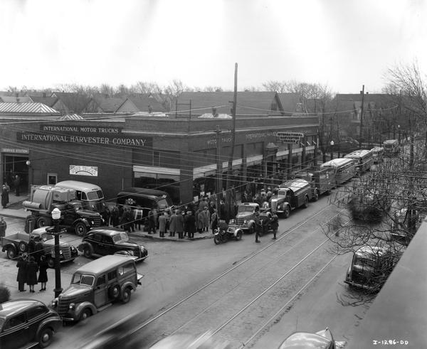 Elevated view of International motor trucks lined up around International Harvester's Buffalo branch house before a parade. The parade was part of the "Annual Spring Driveaway".
