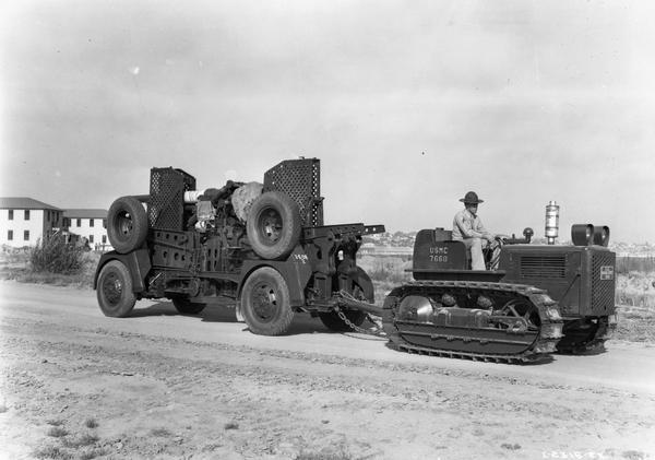 U.S. Marine sergeant transporting field artillery with an International TracTracTor (crawler tractor).