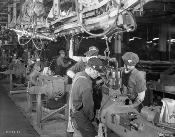 Factory workers on a tractor assembly line at International Harvester's Farmall Works.