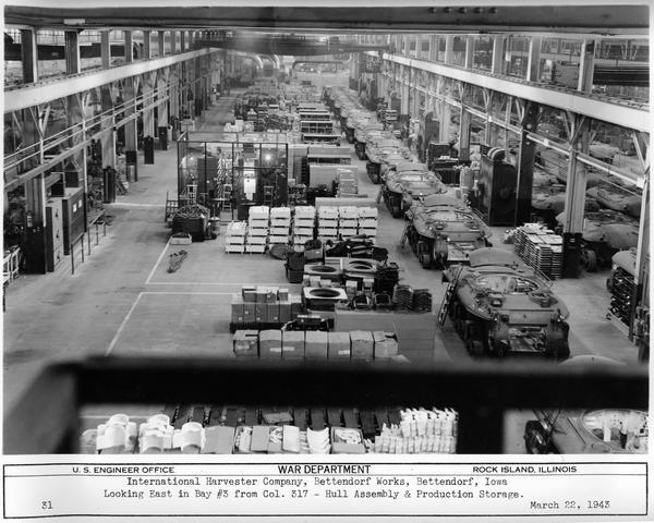 Partially assembled M-7 tanks at International Harvester's Bettendorf Works. Original caption reads: "Looking East in Bay #3 from Col. 317 - Hull Assembly & Production Storage."