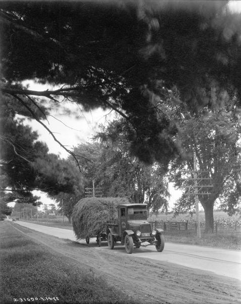 International truck owned by Forestdale Farm hauling hay along a rural Louisiana road.