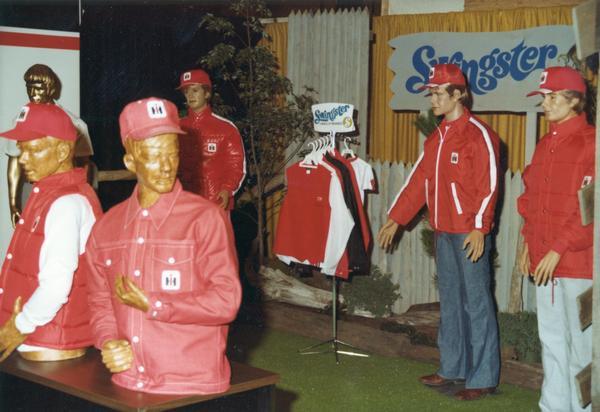 Mannequins dressed in "Swingster" jackets and hats bearing International Harvester colors and logos. The clothing was on display for the introduction of the new International No. 86 series tractor, August-September 1976 at McCormick Place.