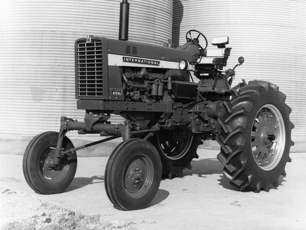 International Hi-Clear 856 tractor in front of grain silos.