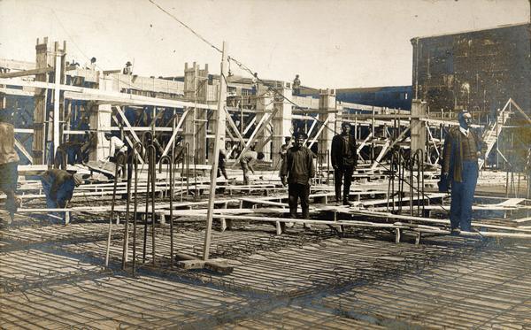 Men, including construction workers, on a building site at International Harvester's Lubertzy Works in Russia.
