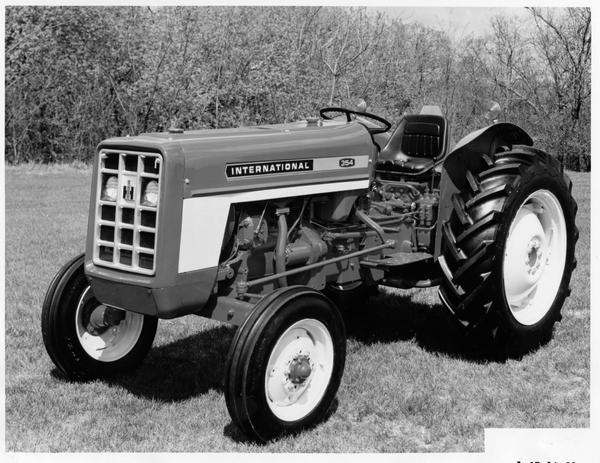 Press release photograph of the International 354 tractor. Original caption reads: "Newest addition to International Harvester Company's low-profile compact utility tractor line is this 32 PTO hp (mfr. est. max.) International 354 tractor. Available in a gasoline or diesel model, the 543 has the same sleek-styling contained in two other low-profile models just introduced by the company to its entire U.S. farm equipment dealer organization."