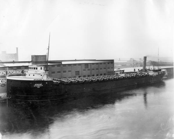 Elevated view of the steamship "Spokane" in port loaded with International Harvester tractors.