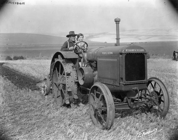 Man and a young girl plowing a field with a McCormick-Deering 15-30 tractor in the Fox Film production "Our Daily Bread".