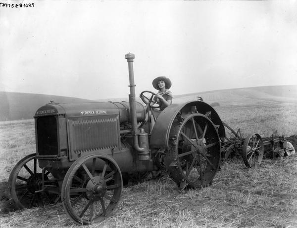 Actress plowing a field with a McCormick-Deering tractor for the Fox Film production "Our Daily Bread."