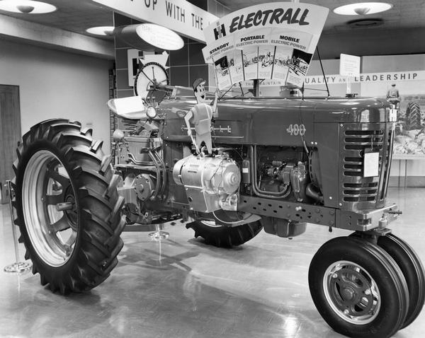 Farmall 400 tractor in a showroom display highlighting the features of the "Electrall" electrical power generator.