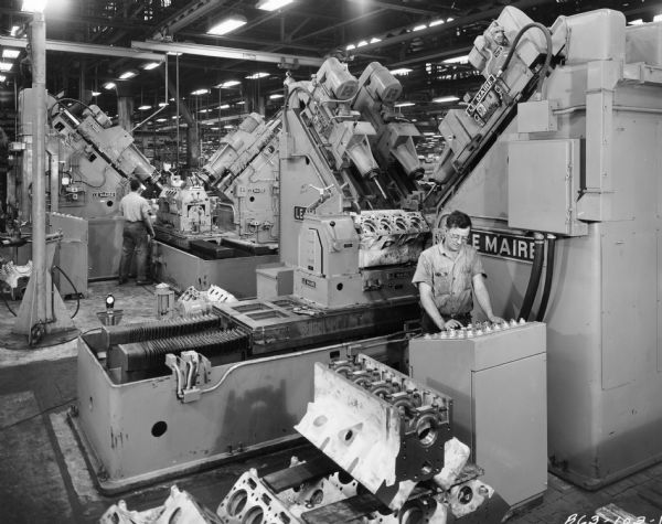 Factory workers producing engines for tractors at International Harvester's Farmall Works.