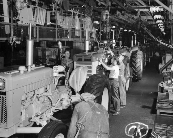 Factory workers on the final tractor assembly line at International Harvester's Farmall Works.