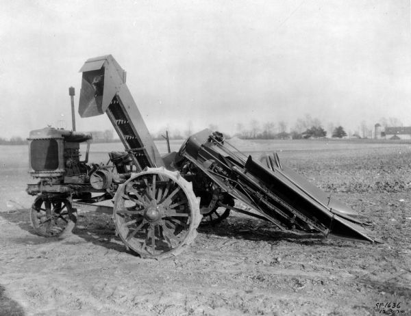 Engineering photograph of an experimental No. 77-A self-powered two-row corn picker in a field. The caption reads: "No. 77-A two-row corn picker development, photographed December 3, 1920."