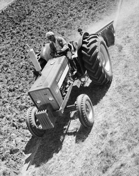 Elevated view of a man plowing a field with a McCormick 624 tractor in Germany.