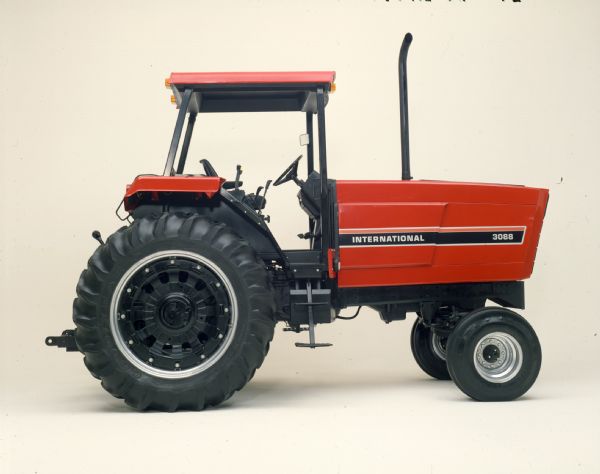 Color photograph of an International 3088 tractor with ROPS (roll-over protection system) in a studio.