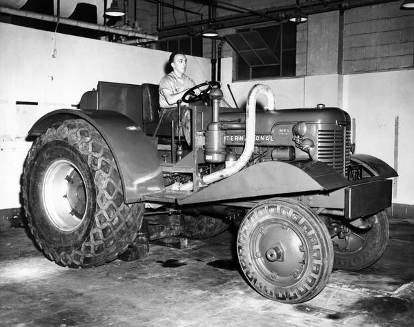 Engineering photograph of a man sitting on an experimental International MRS Special tractor.