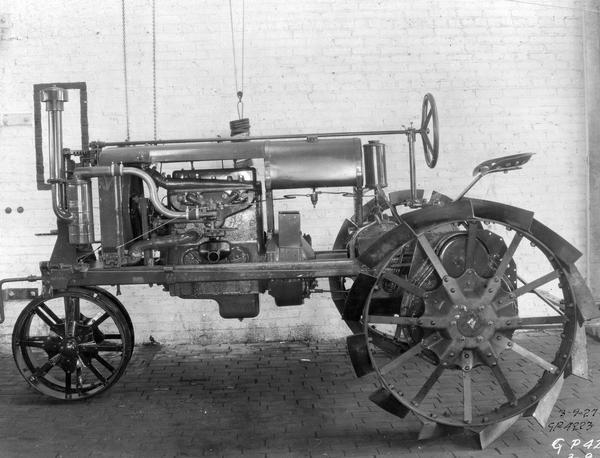 Engineering photograph of an experimental Farmall tractor. Left side view.
