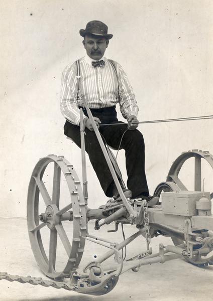 George Lincoln sitting on a Deering mower. The original caption reads:  "George Lincoln on old Deering Mower about 1893."