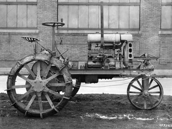 Engineering photograph of an experimental or prototype Farmall tractor outside a factory.