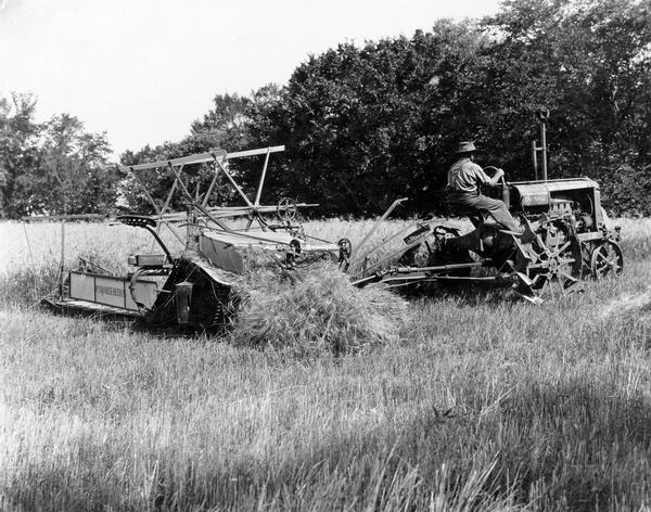 Man pulling a McCormick-Deering power grain binder with a Farmall Regular tractor. The original caption reads: "N-81 Mr. Urfer (himself) with power binder."