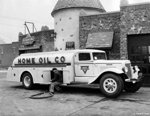 Driver delivering oil to Seiberling Tires with an International Model C-60 oil truck. The truck was owned by the Home Oil Co. of Passaic, New Jersey, and had a 210-inch wheel base.