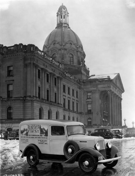 International Model C-1 truck parked in front of Edmonton capitol building in Alberta, Canada. The truck was used to promote tourism in Alberta and is painted with the words: "See Alberta First" and other text describing the province's attractions.
