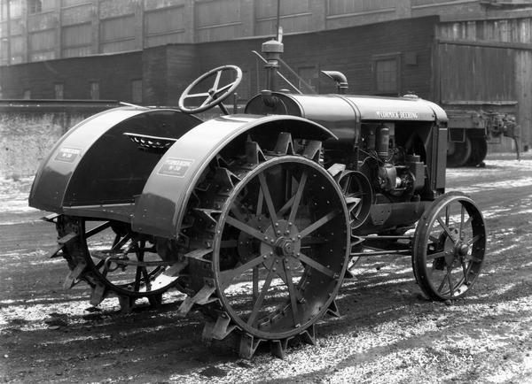 McCormick-Deering W-30 tractor outside a factory.