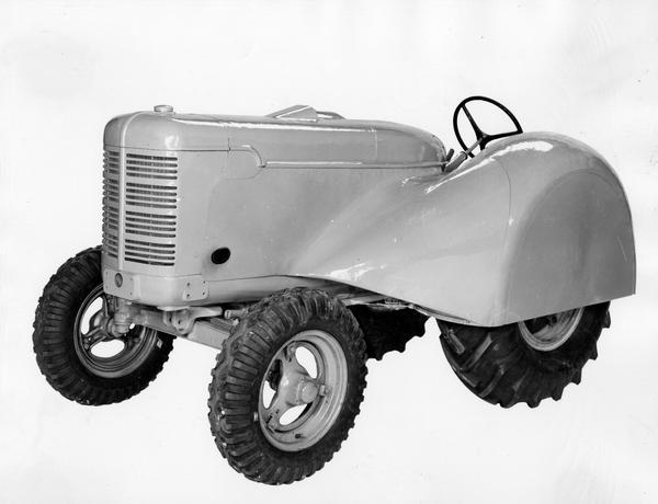 Engineering photograph of an experimental Farmall O-4 orchard tractor. Three-quarter view towards front left.