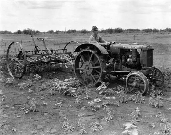Farmer operating a McCormick-Deering W-12 tractor in Niverville, Manitoba, Canada.