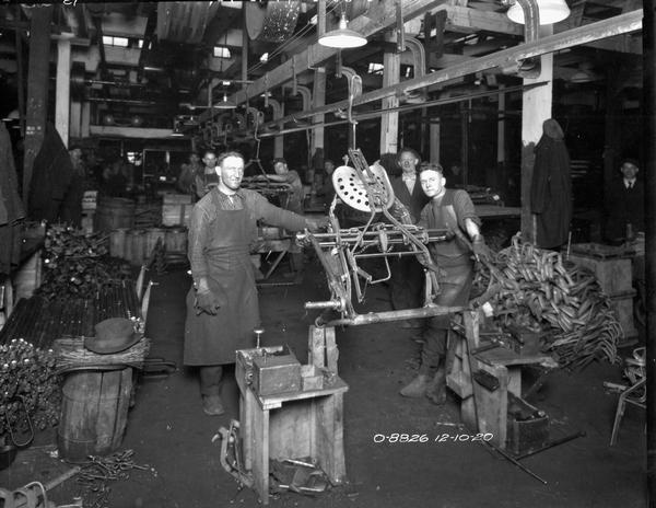 Factory workers on a farm implement assembly line at International Harvester's Osborne Works (later known as Auburn Works).