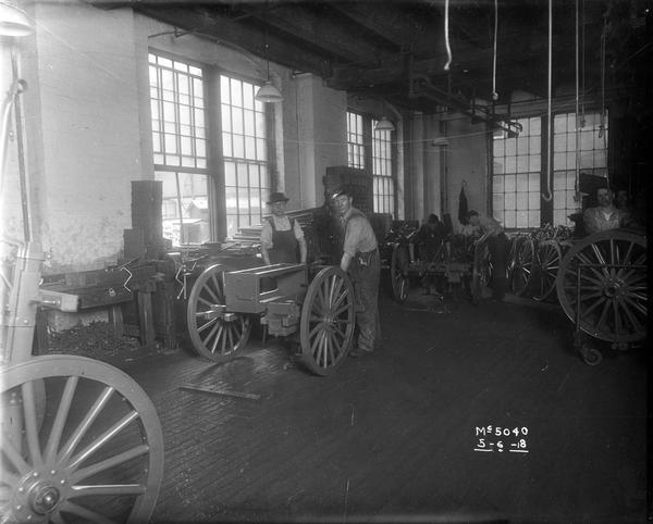 Factory workers assembling artillery or "machine gun" carts for the United States military during World War I at International Harvester's McCormick Works.