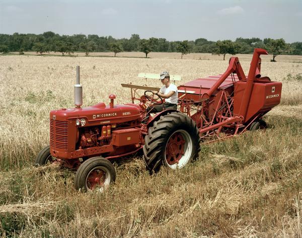 Slightly elevated view of a farmer harvesting grain with a McCormick Super WD-6 tractor and a No. 64 combine (harvester-thresher).