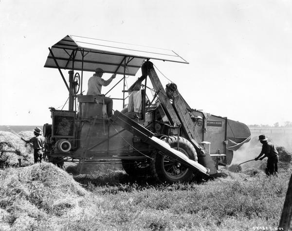 Farmers threshing Ladino clover on the farm of M.M. Laurence with a  McCormick-Deering No. 31-RW West Coast Special harvester-thresher (combine).