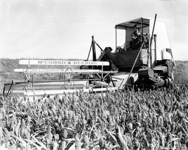 Farmer Frank Rakow harvesting corn with a McCormick-Deering no. 31-RW West Coast Special harvester-thresher (combine). Mr. Rakow and the No. 31-RW are working in a field of Egyptian corn on a 200 acre island farm leased by W.T. Jarrett from Liberty Farms Company. Original caption reads: "The delta region formed at the confluence of the San Joaquin and Sacramento Rivers is broken up into some forty of fifty large islands up to 20,000 acres in size which are protected by dikes and which are usually lower than the rivers. Irrigation is therefore easy, water being siphoned from the adjoining rivers or sloughs. Sub-irrigation, it is called. Since land is very fertile and water plentiful, huge yields prevails. Most of the islands are owned by corporations."
