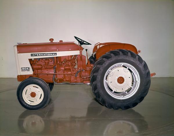 Color photograph of an International 504 tractor in a studio.