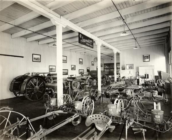 Agricultural implements, machinery and tractors in the showroom of an International Harvester dealership.