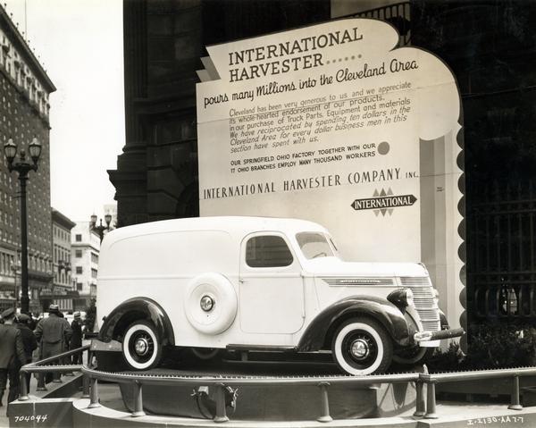 International D-2 panel truck on display in front of the Cleveland Trust Company in downtown Cleveland. The display reads: "International Harvester...pours many millions into the Cleveland area. Cleveland has been very generous to us and we appreciate its whole-hearted endorsement of our products. In our purchase of truck parts, equipment and materials we have reciprocated by spending ten dollars in the Cleveland area for every dollar business men in this section have spent with us. Our Springfield Ohio factory together with our 17 Ohio branches employ many thousand workers."