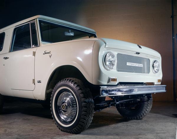 Color advertising photograph of a 1970 International Scout pickup truck with traveltop in a studio.