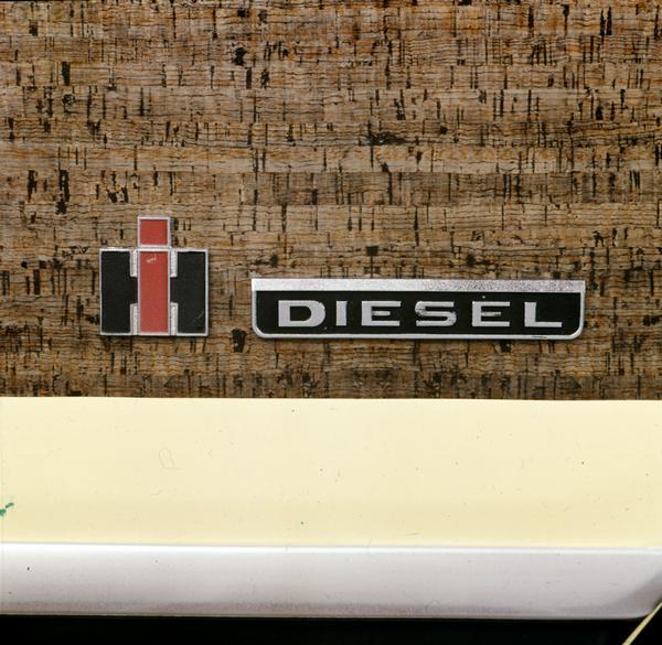 Color advertising photograph of the nameplate for an International Scout diesel truck.