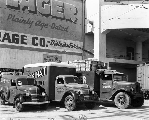 A line of three International delivery trucks at a receiving dock: (from left) D-2, D-40 and A-line trucks. The trucks were owned by Home Ice and Cold Storage Company of California. One truck has Lucky Lager written on the side and another truck has cases of Budweiser and beer kegs on the top.